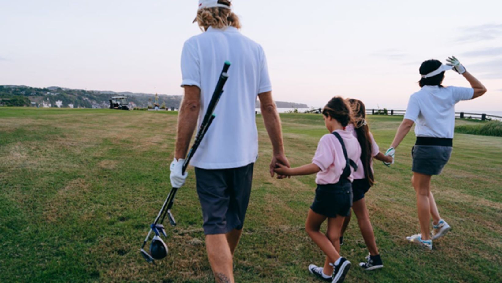 family playing golf together